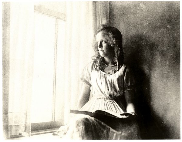 Image of a girl looking out a window.