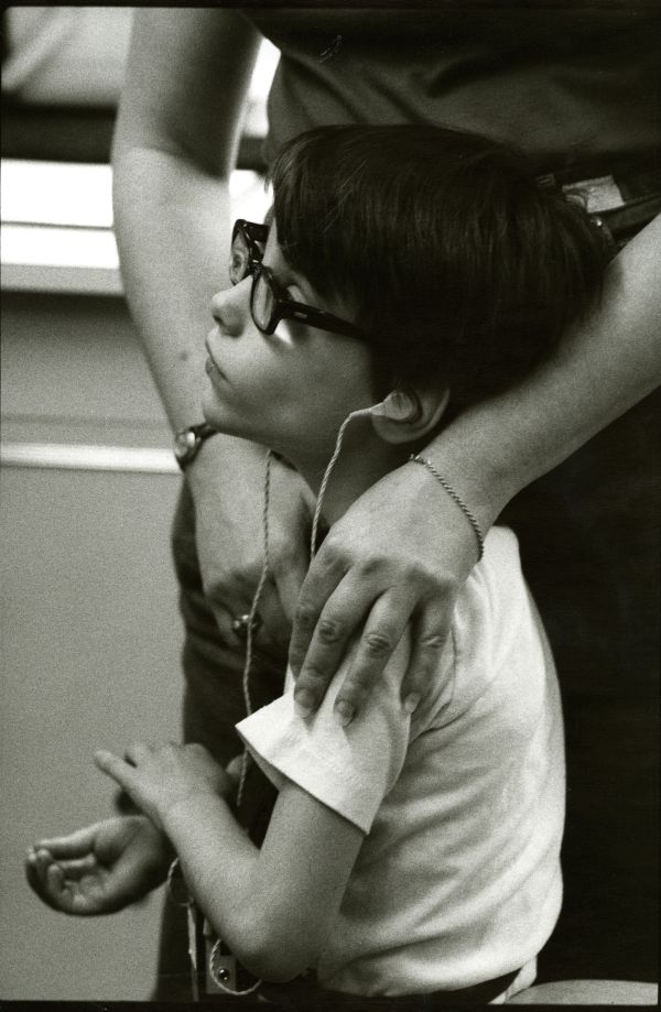 Image of child and parent standing and waiting.