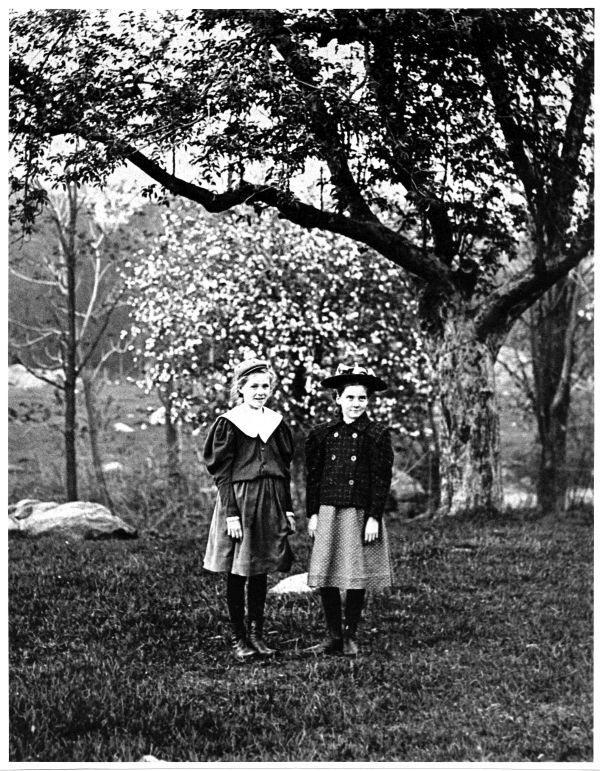 Image of two girls on the grand concourse, under trees.