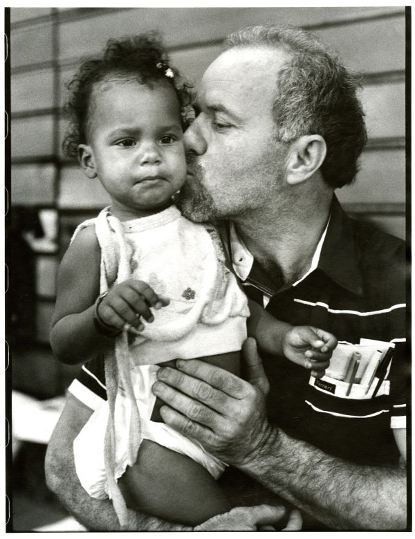 Image of father kissing toddler at Roberto Clemente State Park.