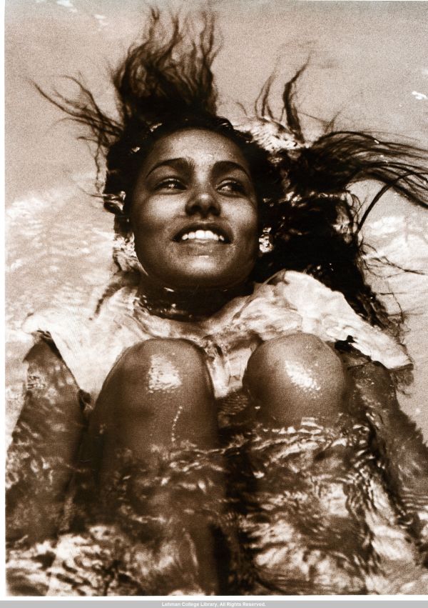 Image of girl swimming on her back.