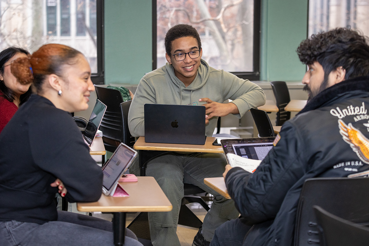 Photo of students discussing a topic in the classroom