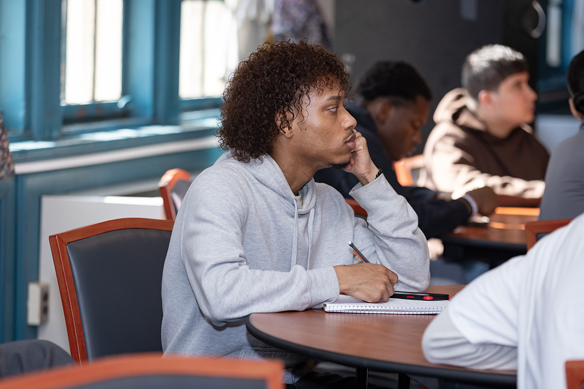 Photo of student in a class writing notes