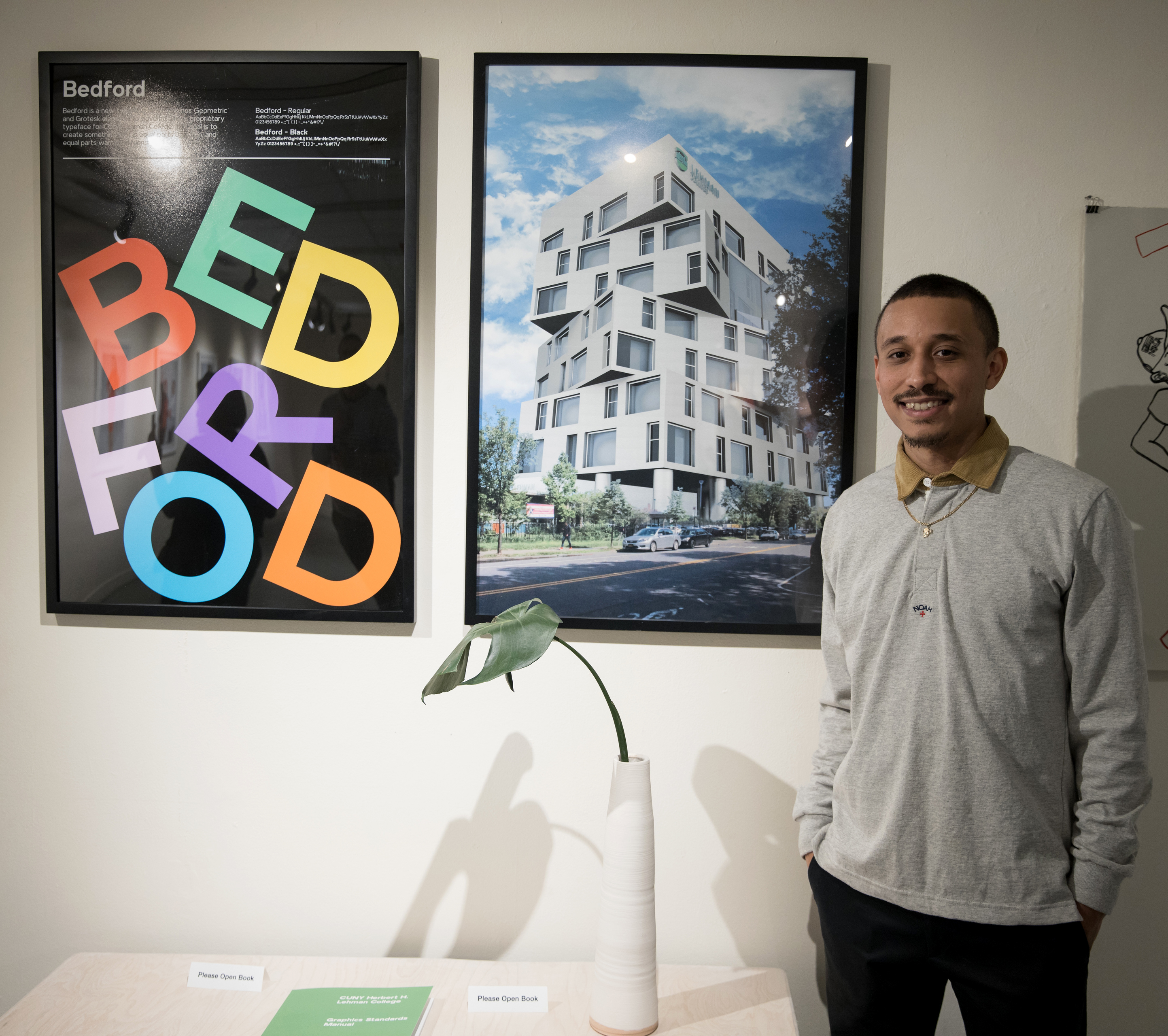 Eric Ramirez '19 poses with his work at his thesis show.