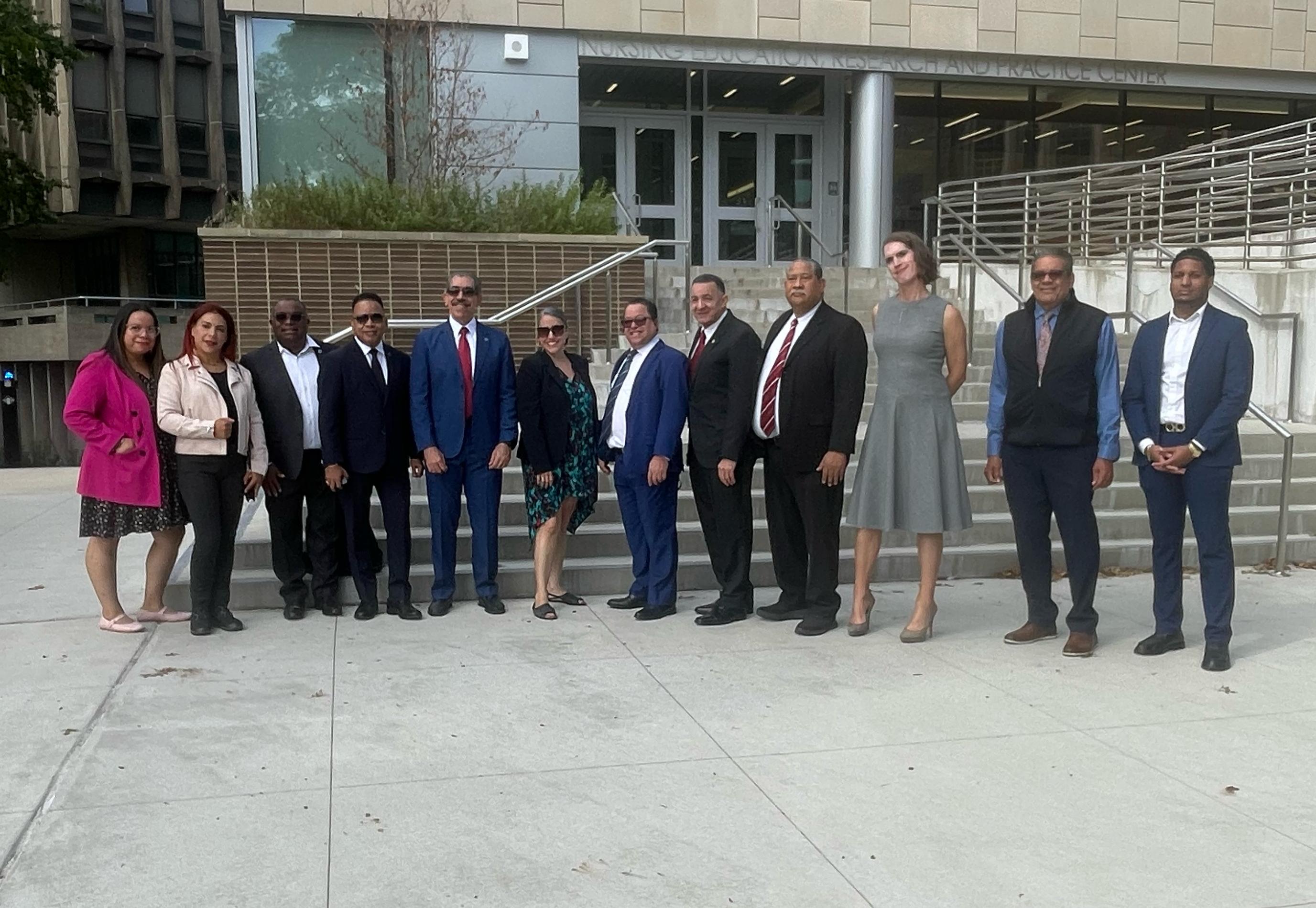 USAD and Lehman College administrators posing in front of the Nursing Education, Research, and Practice building