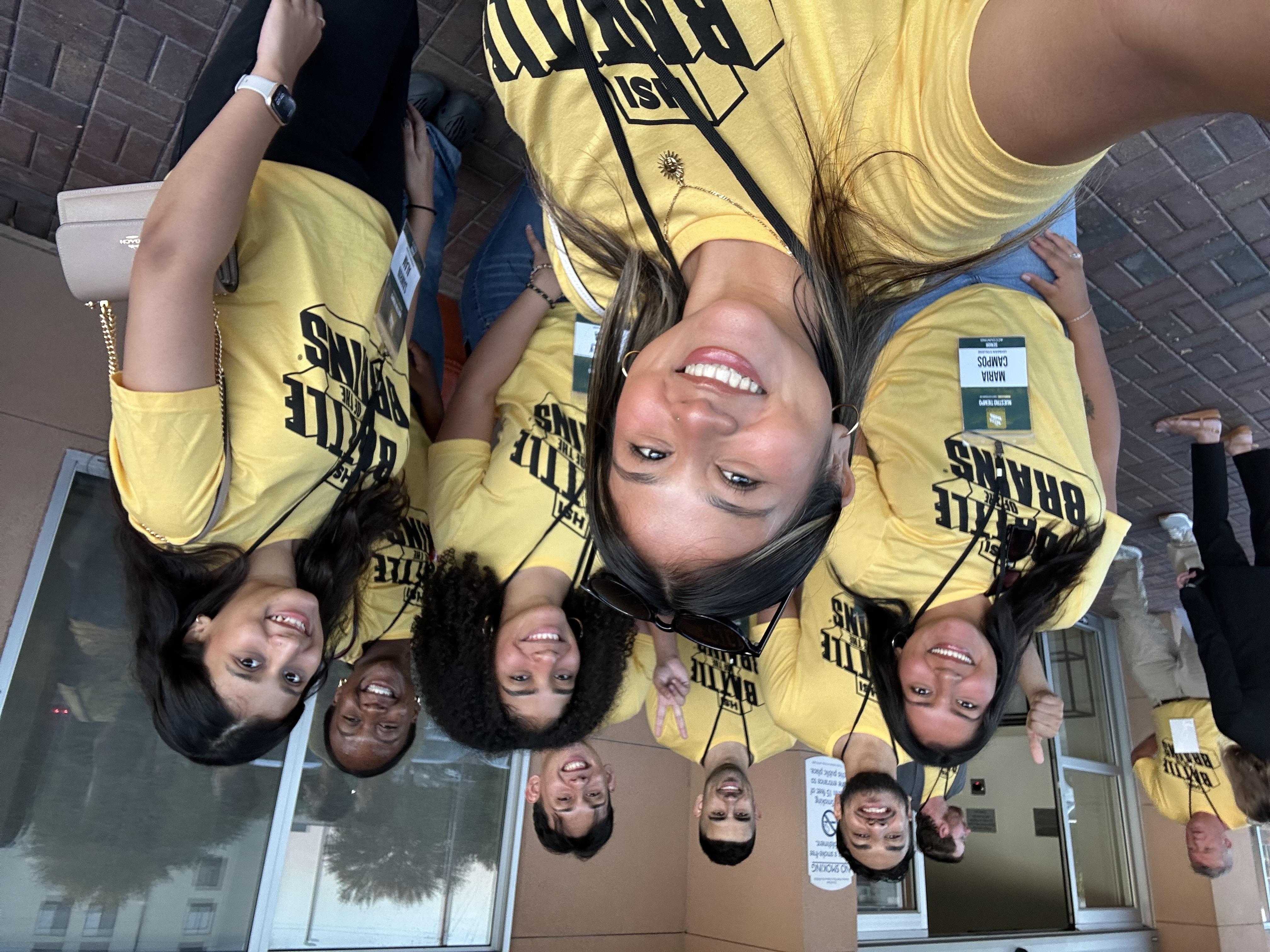 A selfie of a group of students in yellow tee shirts.