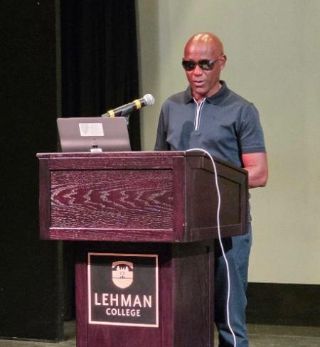 Dight Liburd spaking at podium.