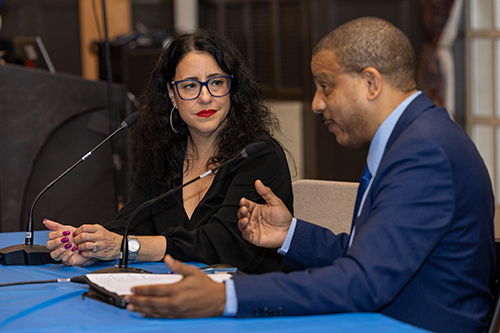 Teresita Levy speaking with Ambassador Yuri Gala López