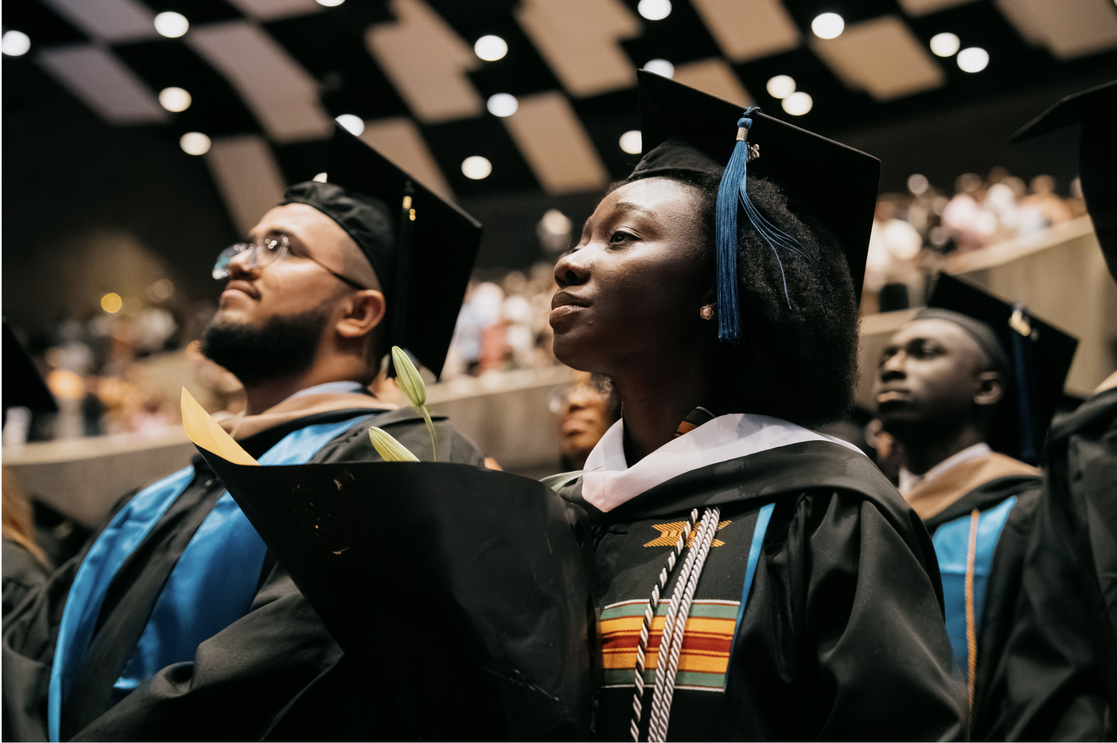 Students in regalia standing at attention at Lehman Center. Photo: Brian Hatton.