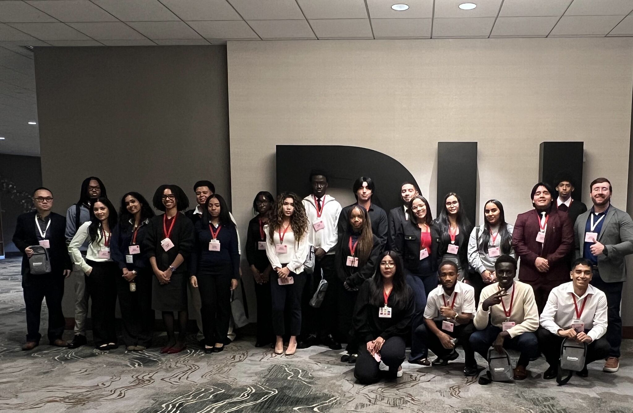 Students from the Lehman School of Business and faculty advisors Ji Yu (left) and Sean Stein Smith (right) at Deloitte University