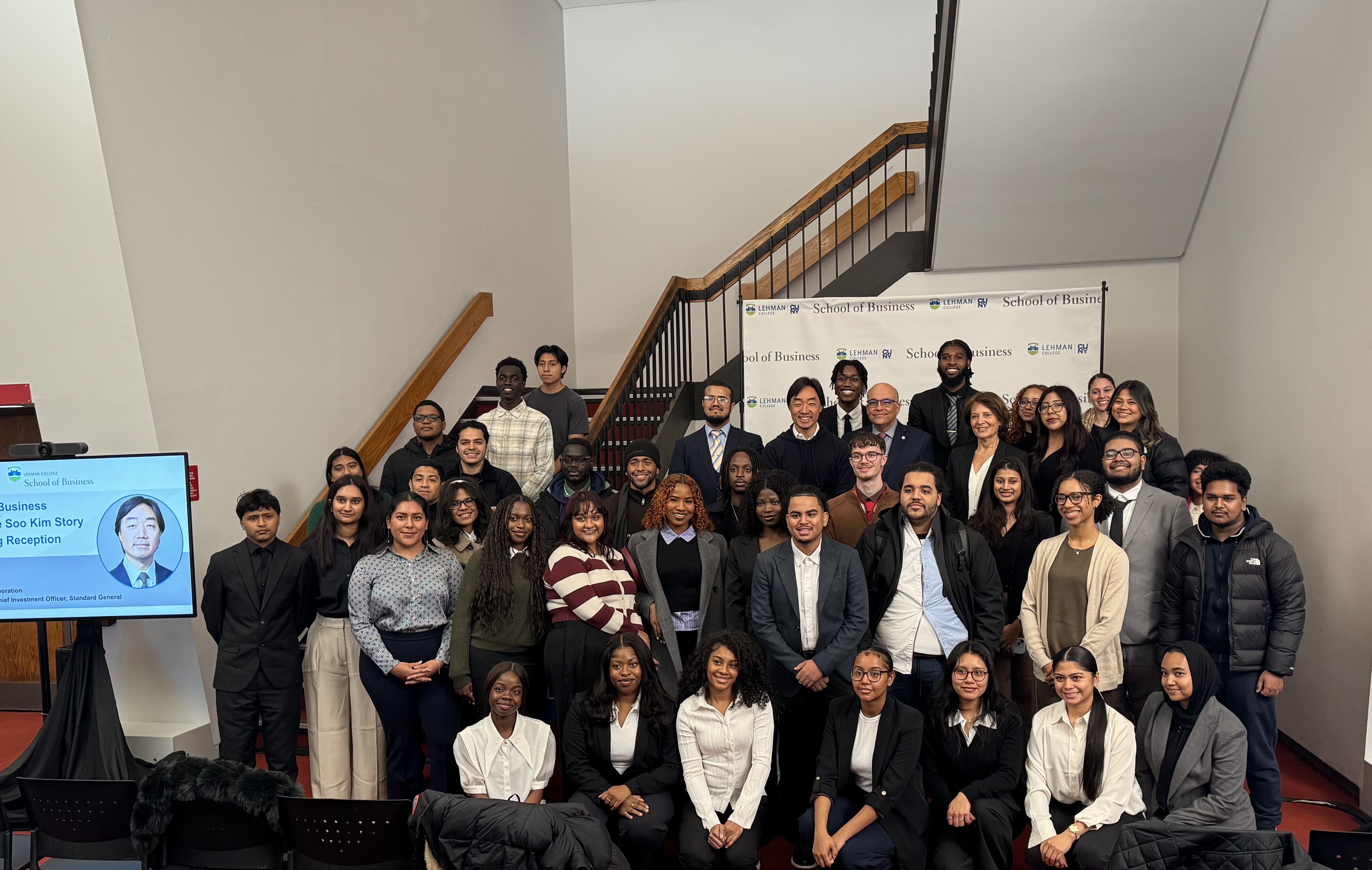 Group photo of Soo Kim, Lehman provost and dean, and students.