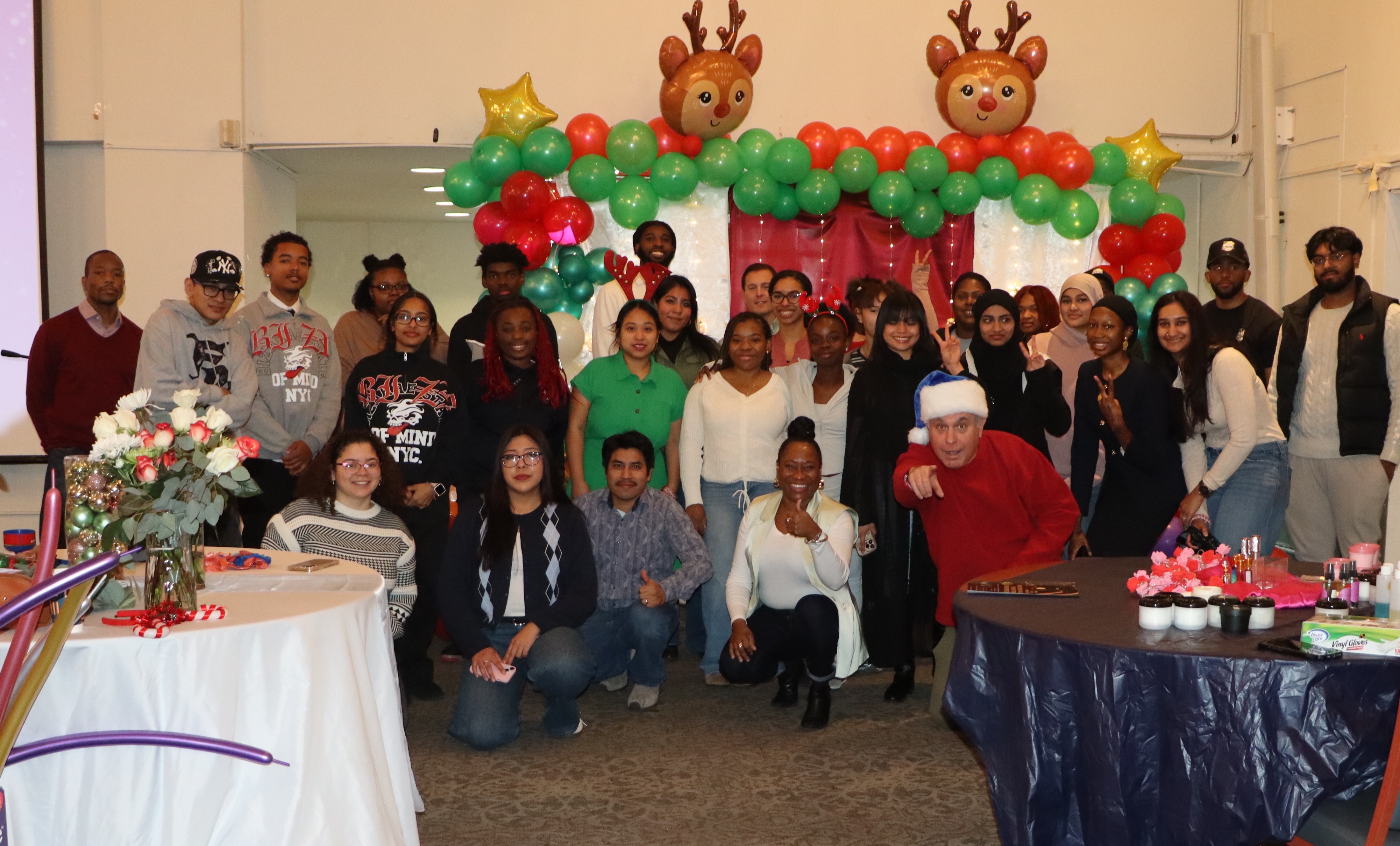 A group of students entrepreneurs and Professor Andy Gold pose together at the Holiday Market
