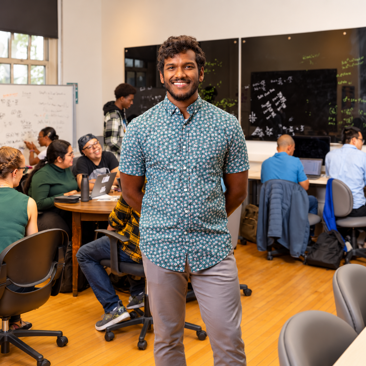 Smiling Student in a Collaborative Tech Lab