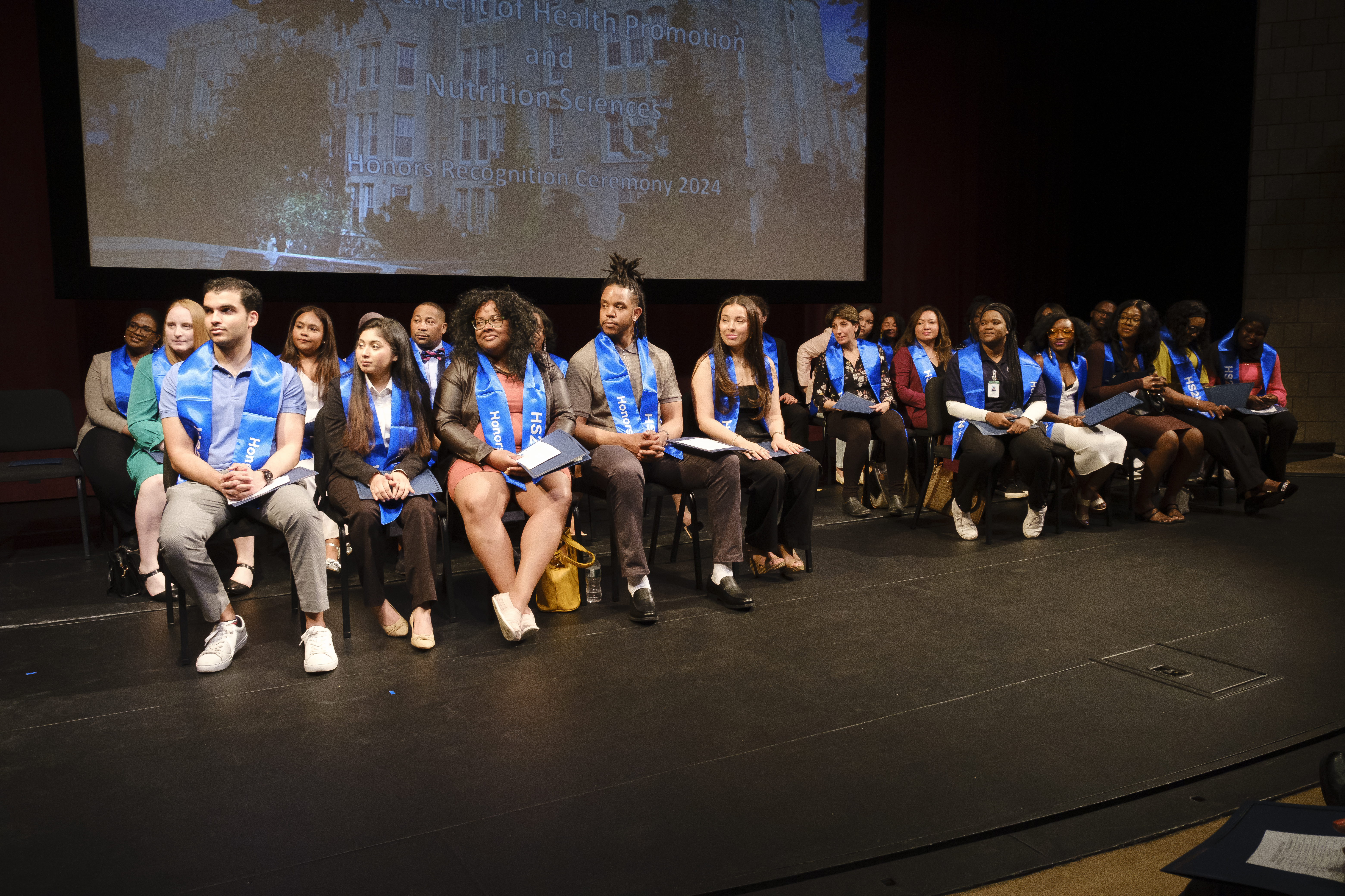 HPNS students sitting on stage during their honors ceremony
