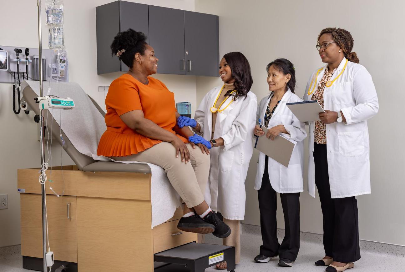 Nursing Graduate student examining a patient