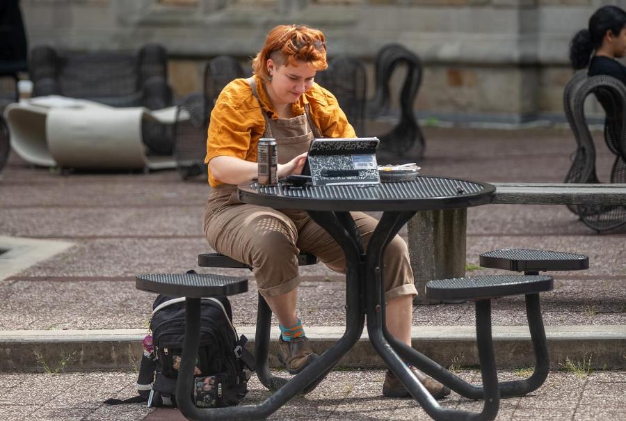 Students sitting on a table outside