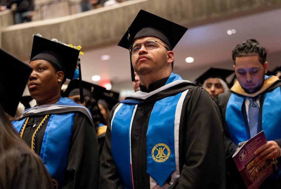 Students at commencement looking up