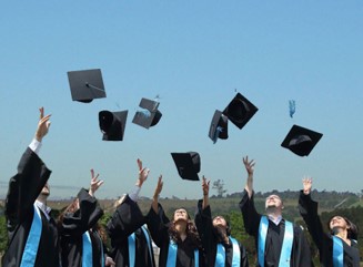 Photo of graduates tossing their caps