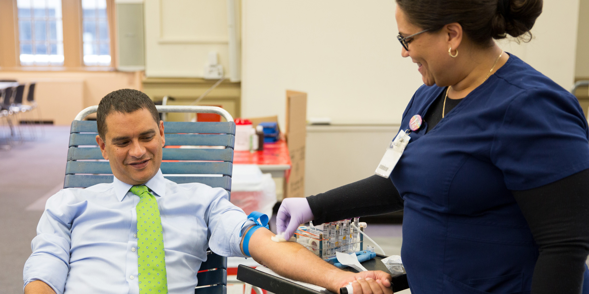 Lehman College President José Luis Cruz donates blood at the campus blood drive.